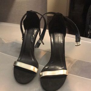 Black heels open toed with a gold band
